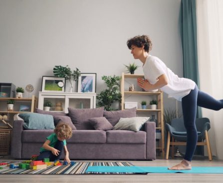 a woman and a child playing in a living room